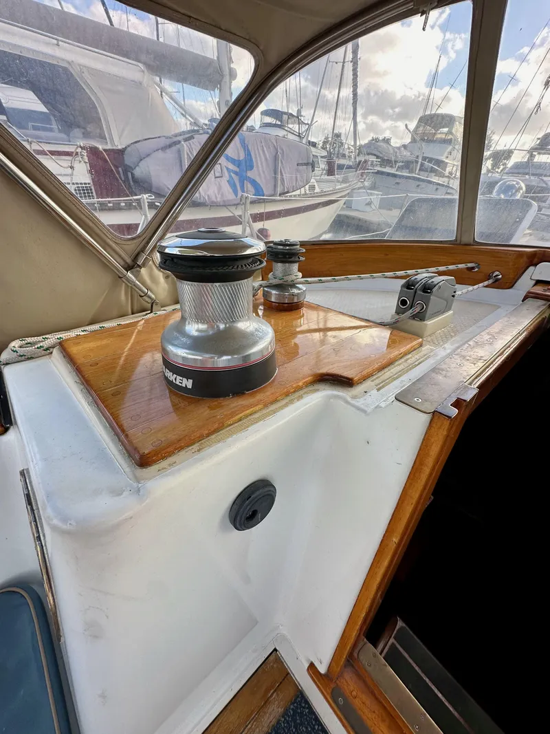 Slide: The Image of 1985 Shannon 43 Classic Cutter sailboat cockpit with winch and wooden trim. - 47