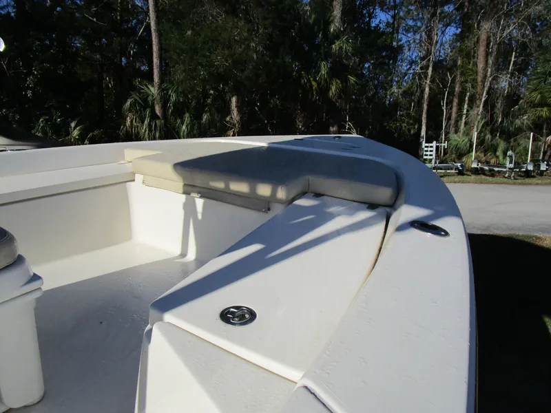 Slide: The Image of 2016 Pathfinder 2200 TRS boat interior with seating, surrounded by trees. - 10