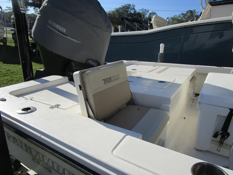 Slide: The Image of 2016 Pathfinder 2200 TRS boat interior with Yamaha engine cover, showcasing seating and storage. - 3