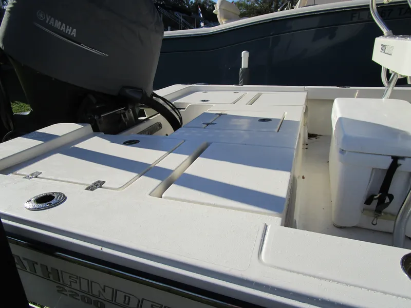Slide: The Image of 2016 Pathfinder 2200 TRS boat deck with Yamaha engine cover, featuring storage compartments. - 7