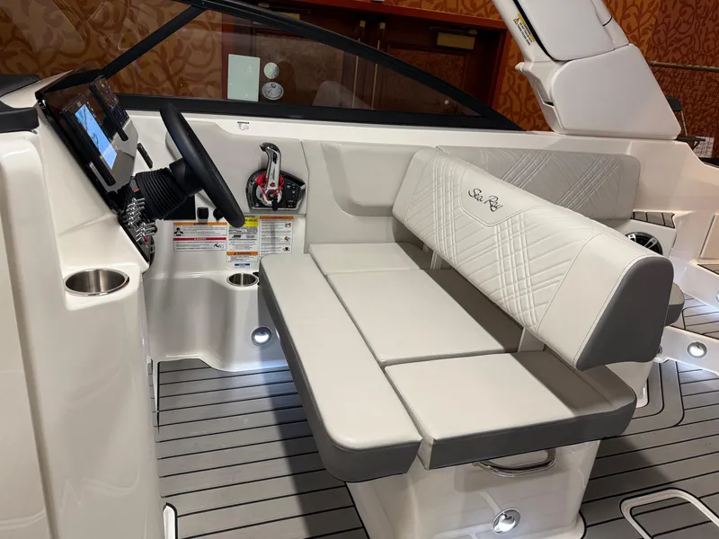 Slide: The Image of 2024 Sea Ray SLX 260 boat interior with luxurious seating and modern dashboard. - 13