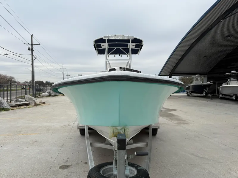 Slide: The Image of 2012 Blazer 2400 boat on trailer, parked outdoors near a storage facility. - 10