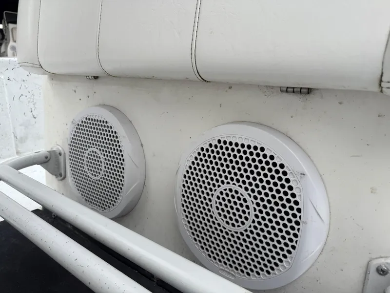 Slide: The Image of Boat speakers on a 2012 Blazer 2400, mounted under white seating. - 16
