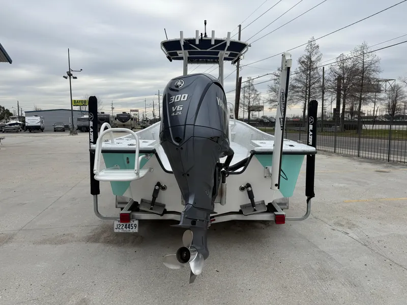 Slide: The Image of 2012 Blazer 2400 boat with Yamaha 300 V6 engine, parked outdoors. - 20