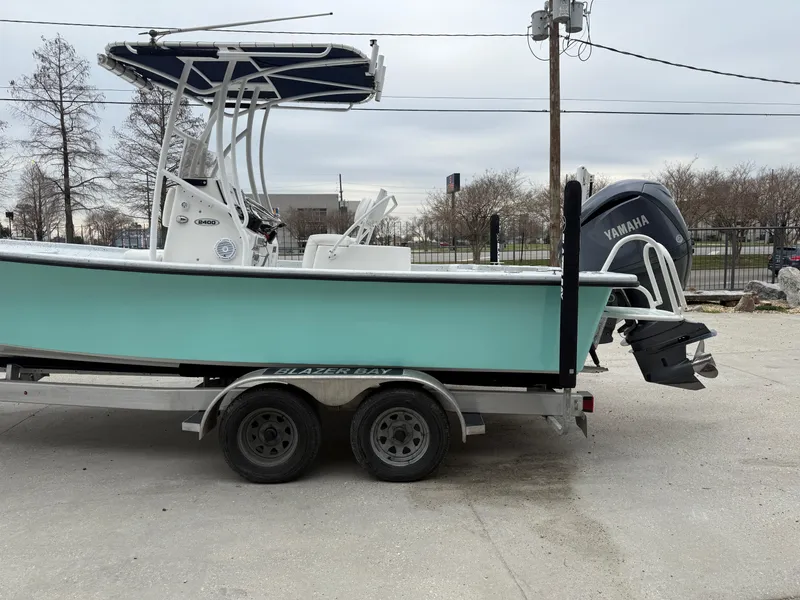Slide: The Image of 2012 Blazer 2400 boat on trailer with Yamaha outboard motor. - 22