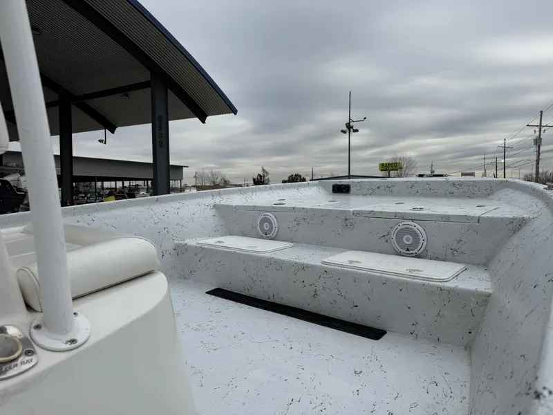 Slide: The Image of 2012 Blazer 2400 boat interior with seating and speakers under cloudy sky. - 25