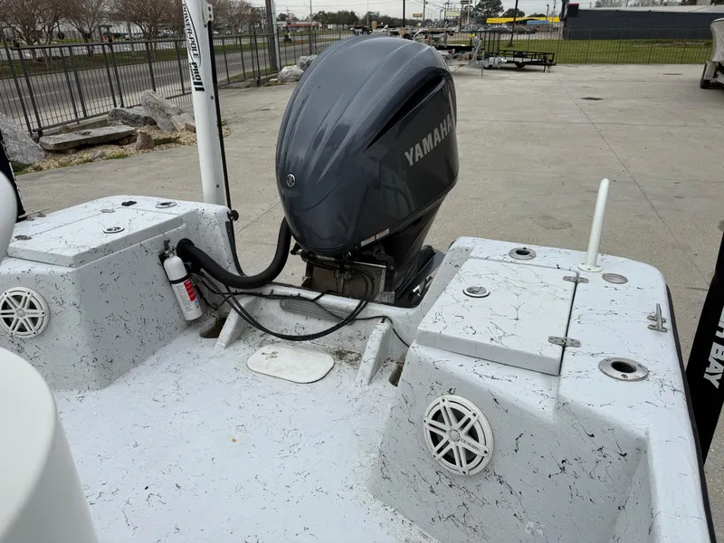 Slide: The Image of 2012 Blazer 2400 boat with Yamaha outboard motor, docked on concrete surface. - 26