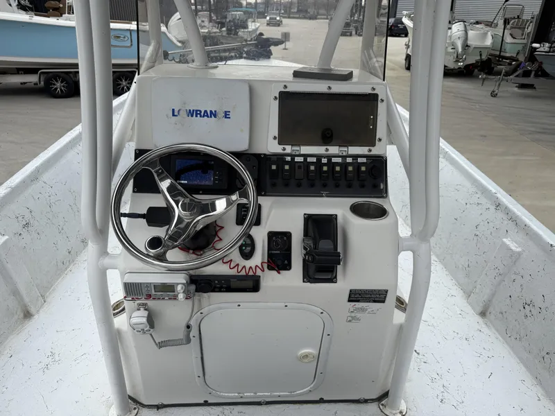 Slide: The Image of Console of a 2012 Blazer 2400 boat with steering wheel and navigation equipment. - 5