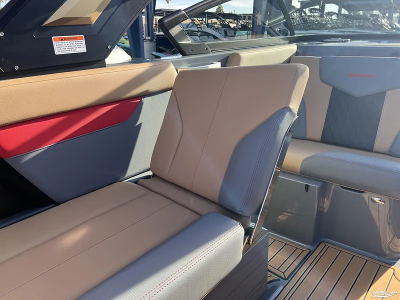 Slide: The Image of 2025 MasterCraft XT25 interior with beige and gray seating, featuring modern design and premium materials. - 16
