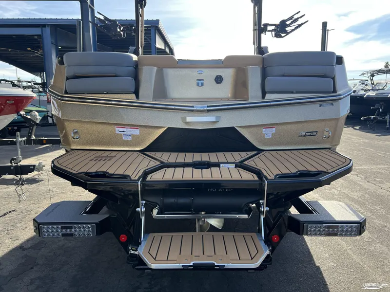 Slide: The Image of 2025 MasterCraft XT25 boat rear view with swim platform and seating. - 3