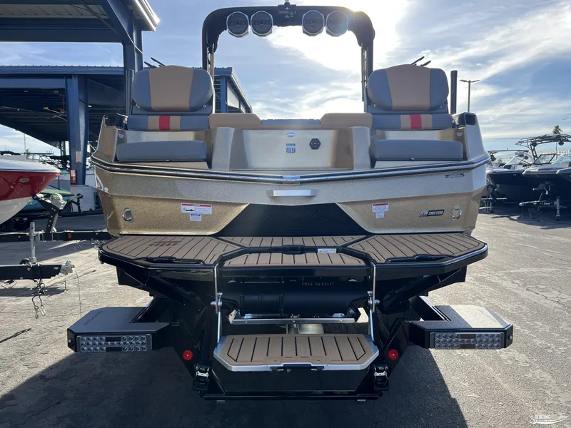 Slide: The Image of 2025 MasterCraft XT25 boat rear view, featuring sleek design and modern seating. - 4