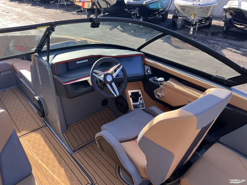 Slide: The Image of 2025 MasterCraft XT25 boat interior with modern dashboard and seating. - 6