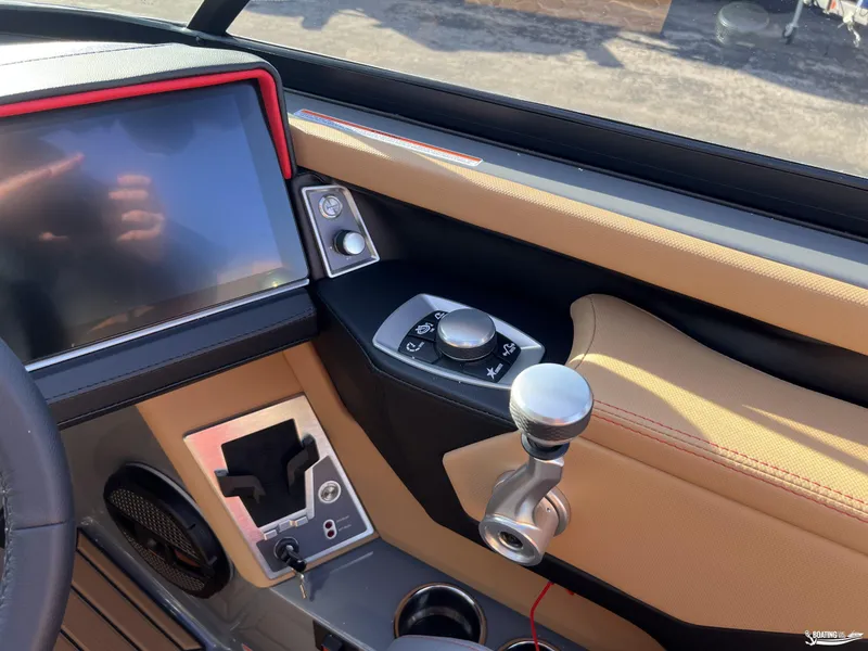 Slide: The Image of 2025 MasterCraft XT25 boat dashboard with touchscreen and control knobs. - 8