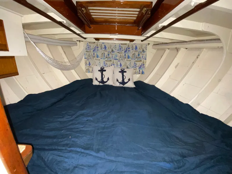 Slide: The Image of Cozy 1962 Cheoy Lee Custom boat cabin with nautical decor and blue bedding. - 10
