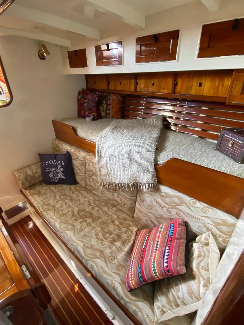 Slide: The Image of 1962 Cheoy Lee Custom yacht interior with cozy wooden furnishings and patterned cushions. - 12