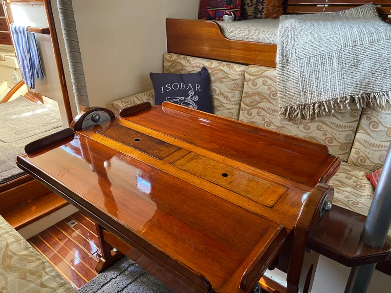 Slide: The Image of 1962 Cheoy Lee Custom yacht interior with polished wood table and cozy seating area. - 15
