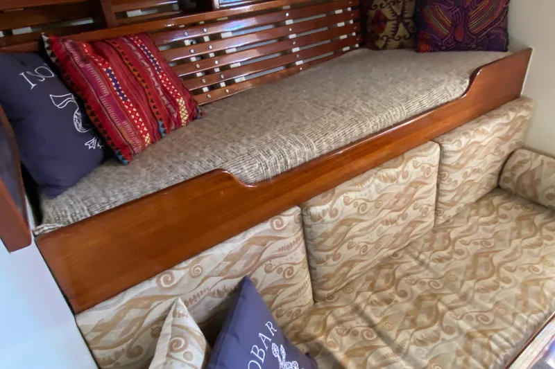 Slide: The Image of 1962 Cheoy Lee Custom interior with wooden accents and patterned cushions. - 18