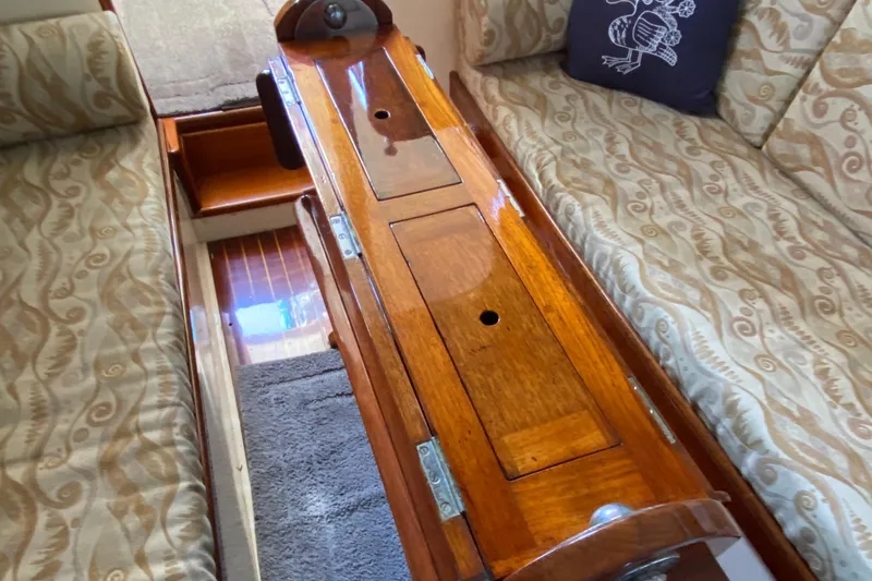 Slide: The Image of 1962 Cheoy Lee Custom yacht interior with wooden table and patterned seating. - 19