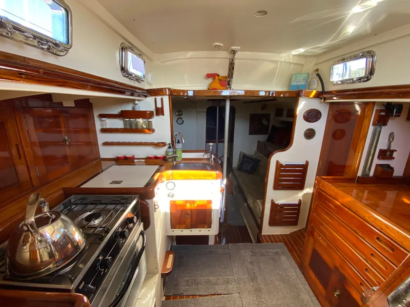 Slide: The Image of Interior of 1962 Cheoy Lee Custom yacht with wooden cabinetry and modern kitchen amenities. - 2