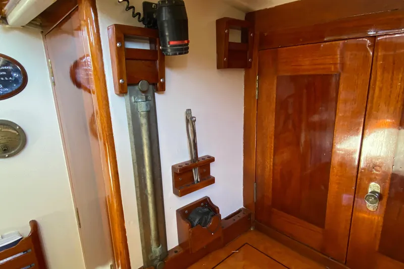 Slide: The Image of 1962 Cheoy Lee Custom yacht interior with polished wood and nautical equipment. - 31