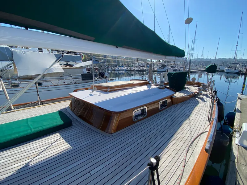 Slide: The Image of 1962 Cheoy Lee Custom yacht with wooden deck and green canopy, docked at a marina. - 34