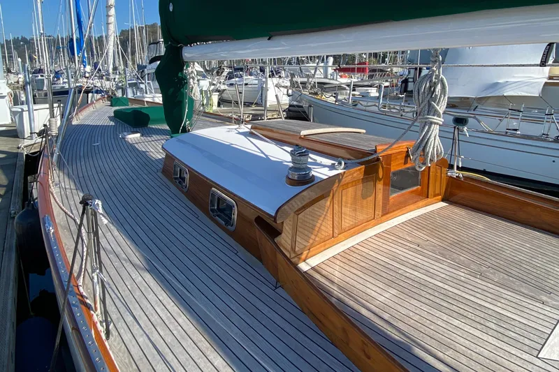 Slide: The Image of 1962 Cheoy Lee Custom sailboat with wooden deck and cabin, docked in a marina. - 35