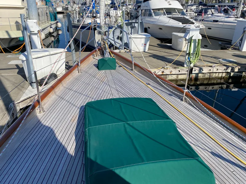 Slide: The Image of 1962 Cheoy Lee Custom yacht deck with green covers, docked at a marina. - 36