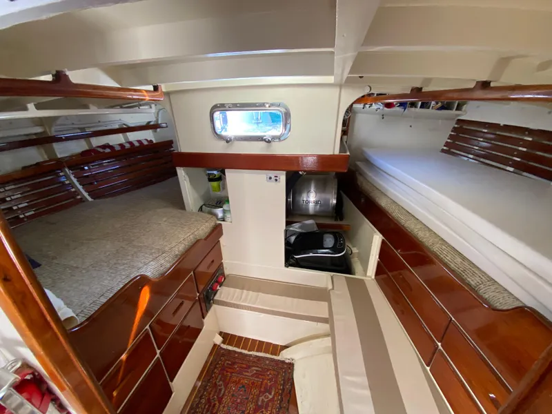 Slide: The Image of Interior of 1962 Cheoy Lee Custom yacht with wooden furnishings and cozy sleeping area. - 4