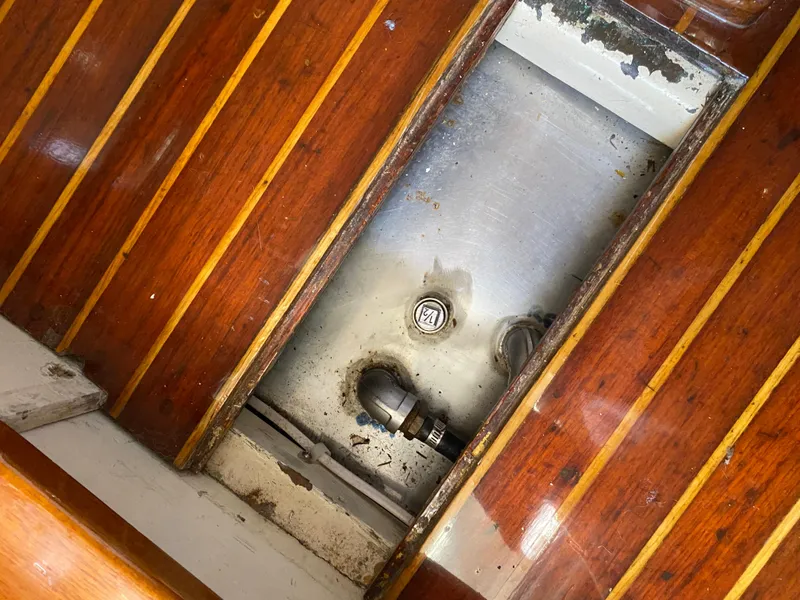 Slide: The Image of 1962 Cheoy Lee Custom boat interior with wooden flooring and visible metal components. - 42
