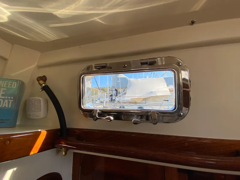 Slide: The Image of 1962 Cheoy Lee Custom yacht interior with porthole view and nautical decor. - 43