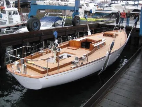 Slide: The Image of 1962 Cheoy Lee Custom yacht docked, showcasing elegant wooden deck and classic design. - 46