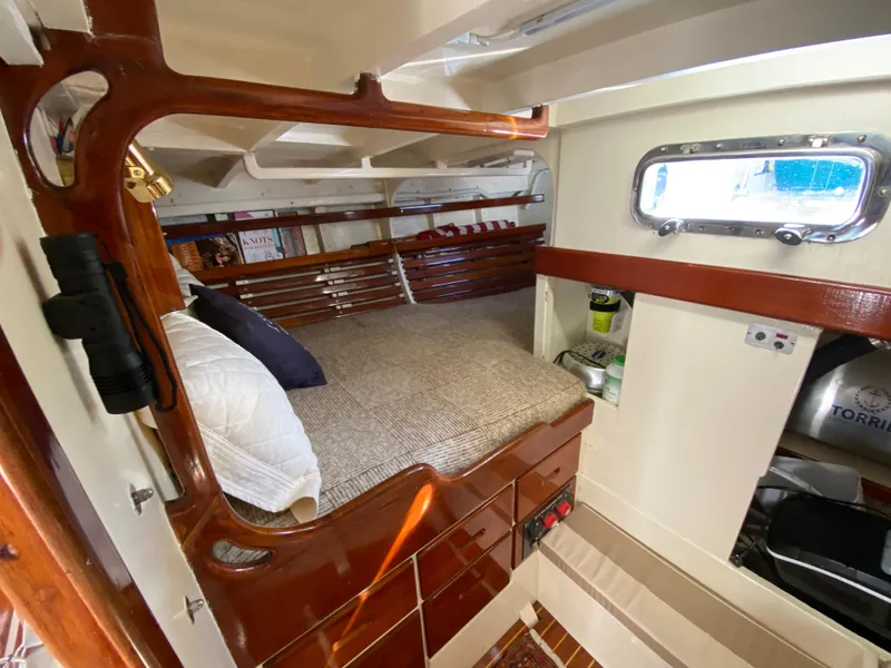 Slide: The Image of 1962 Cheoy Lee Custom yacht interior with cozy wooden cabin and bed. - 5