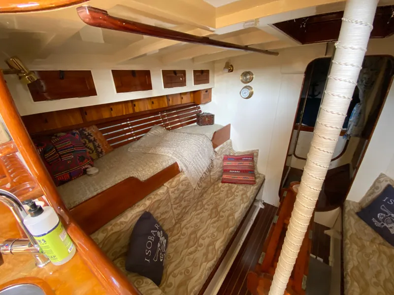 Slide: The Image of 1962 Cheoy Lee Custom yacht interior with cozy bedding and wooden accents. - 7