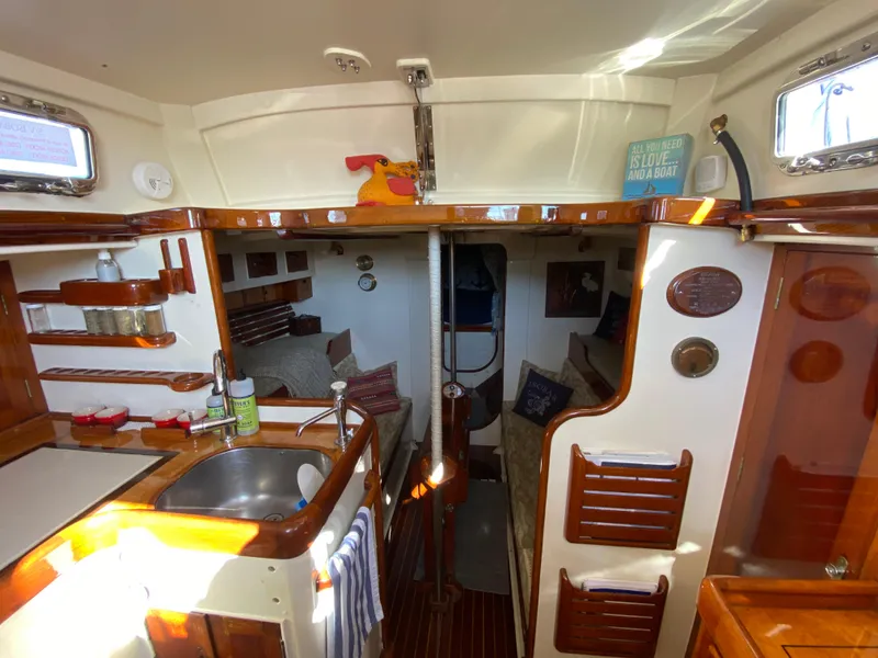 Slide: The Image of Interior of a 1962 Cheoy Lee Custom yacht, featuring a cozy kitchen and sleeping area. - 9