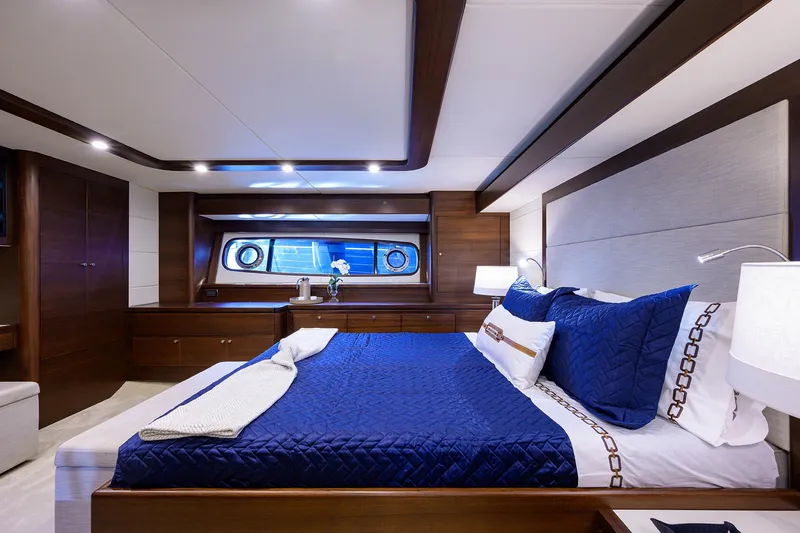 Slide: The Image of Luxurious bedroom interior of 2026 Grand Banks GB 85 yacht with elegant blue bedding. - 11