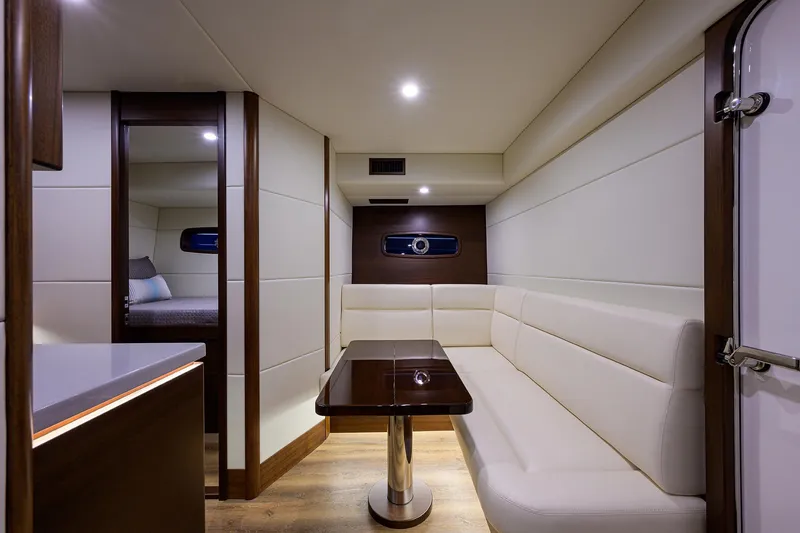 Slide: The Image of Luxurious interior of 2026 Grand Banks GB 85 yacht with elegant seating and table. - 13