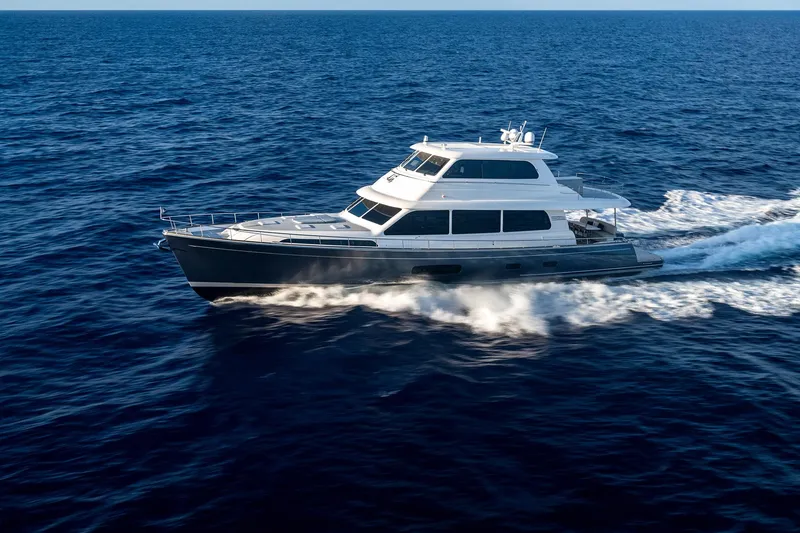 Slide: The Image of 2026 Grand Banks GB 85 yacht cruising on open ocean waters. - 17
