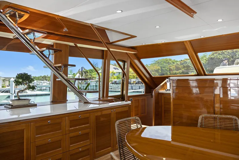 Slide: The Image of Luxurious interior of 2026 Grand Banks GB 85 yacht with wooden finishes and marina view. - 24