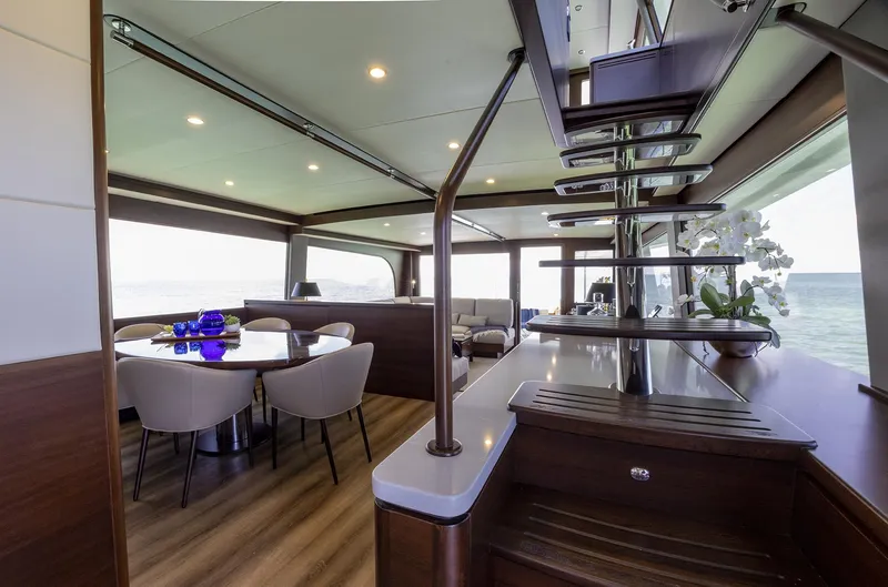 Slide: The Image of Luxurious interior of 2026 Grand Banks GB 85 yacht with modern dining area and elegant decor. - 5