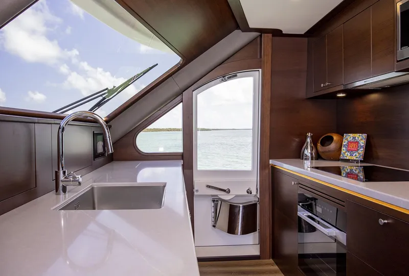 Slide: The Image of Modern kitchen interior of 2026 Grand Banks GB 85 yacht with sleek design and ocean view. - 7