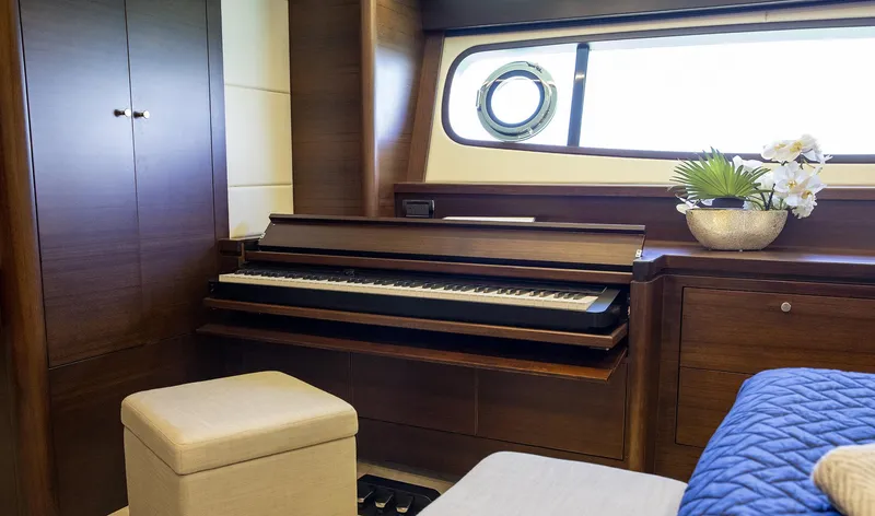 Slide: The Image of Luxurious interior of 2026 Grand Banks GB 85 yacht with piano and elegant decor. - 9