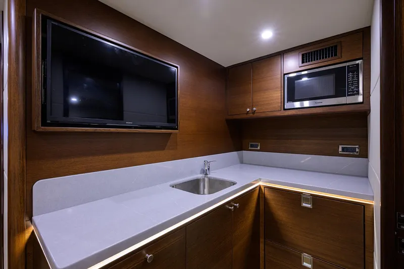 Slide: The Image of Modern kitchen area in 2026 Grand Banks GB 85 yacht with TV and microwave. - 22