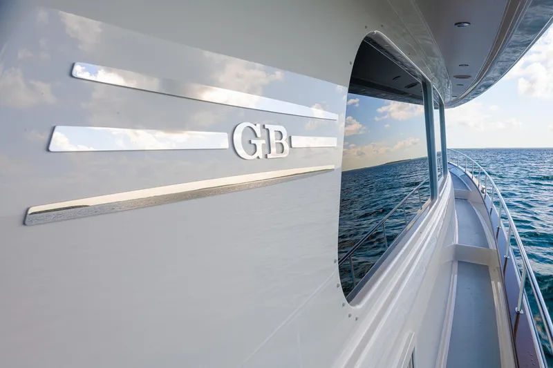 Slide: The Image of 2026 Grand Banks GB 85 yacht cruising on open water, sleek design and ocean reflection. - 3