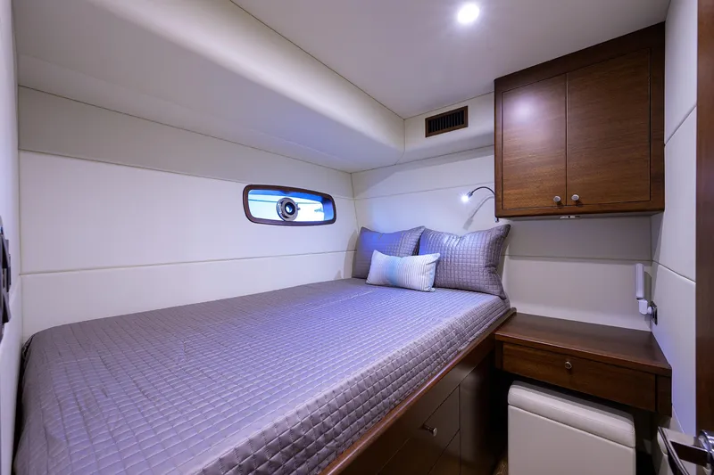 Slide: The Image of Luxurious cabin interior of 2026 Grand Banks GB 85 yacht with cozy bed and wooden cabinetry. - 14