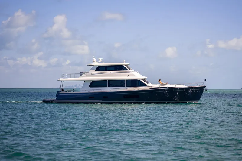 Slide: The Image of 2026 Grand Banks GB 85 yacht cruising on open water under a clear sky. - 18