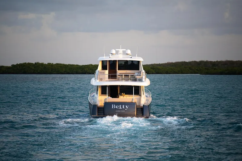 Slide: The Image of 2026 Grand Banks GB 85 yacht cruising on open water. - 21