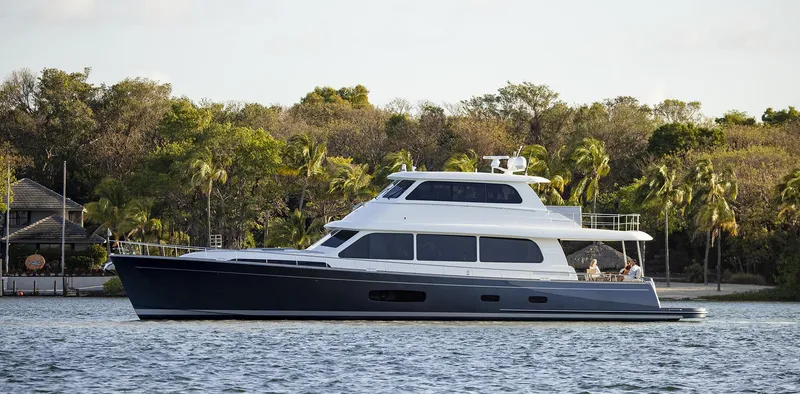 Slide: The Image of 2026 Grand Banks GB 85 yacht cruising on a serene waterway. - 27