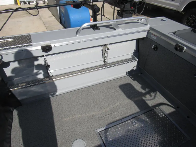Slide: The Image of 2023 Hewescraft 210 Sea Runner ET boat interior with storage compartments and metal flooring. - 10