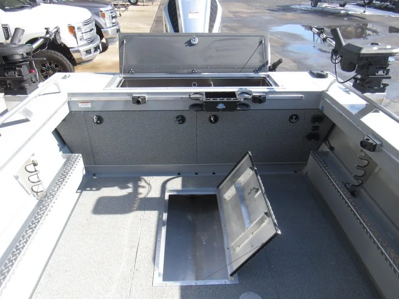 Slide: The Image of 2023 Hewescraft 210 Sea Runner ET boat interior with storage compartments and fishing equipment. - 11