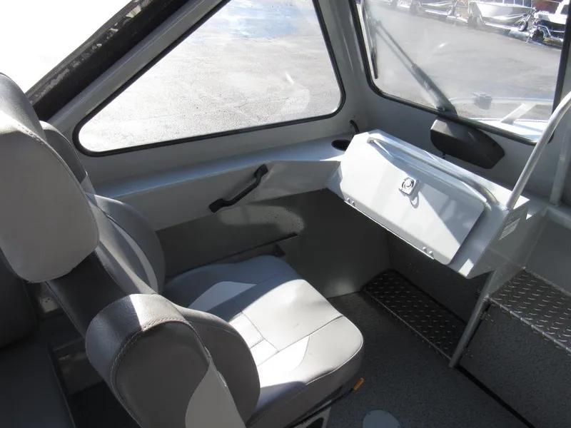 Slide: The Image of 2023 Hewescraft 210 Sea Runner ET interior with seating and dashboard view. - 13
